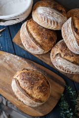 Artisan Batard Sourdough healthy Bread with leaf scoring. Open crumb high hydration Sourdough bread set on white table. - 579360302