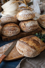 Artisan Batard Sourdough healthy Bread with leaf scoring. Open crumb high hydration Sourdough bread set on white table.