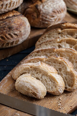 Artisan Batard Sourdough healthy Bread with leaf scoring. Open crumb high hydration Sourdough bread set on white table. - 579360313