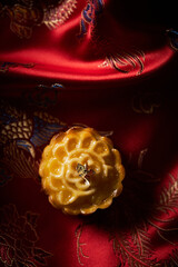 Mooncake a Chinese traditional pastry for Mid-Autumn festival. set on red chinese fabric. - 579360358