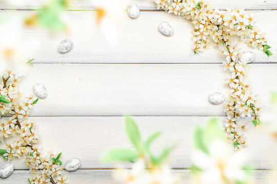 Easter background wood. Sakura blossom flower, white happy easter eggs on wood spring background. Easter design. Top view. Flat lay.