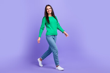 Fototapeta na wymiar Full length profile side photo of young woman walking forward shopping store mall center isolated purple color background