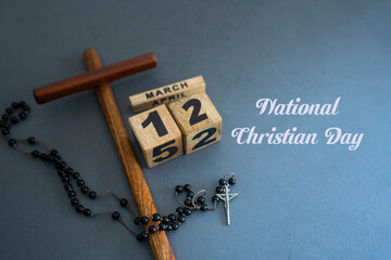 National Christian Day concept, March 12th Wooden cross prayer beads and date Selective focus