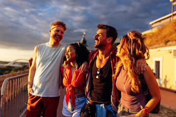 Friends enjoying sunset at music festival