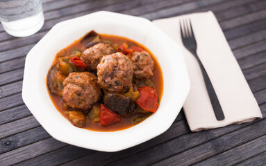 steamed meatballs with stewed vegetables on plate