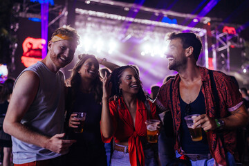 Young cheerful people having fun at concert