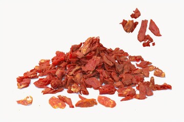 a heap of dried, chopped tomatoes, displayed against a white background. Flakes of tomato. Generative AI