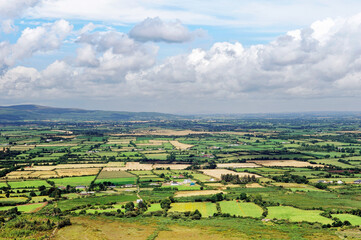 Fototapeta na wymiar The Knockmealdown Mountains near Clogheen. Co. Tipperary, Ireland. North over farmland toward Caher from Sugarloaf Hill