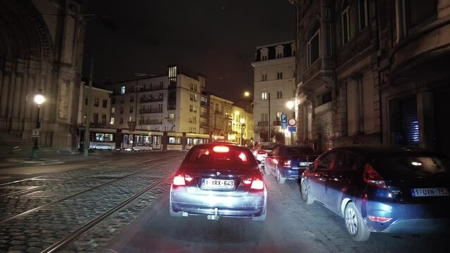 Real time dashcam footage of a car driving on the road at night in Brussels, Belgium