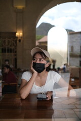 Dark-skinned woman wearing a black mask to prevent COVID-19