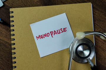 Concept of Menopause write on sticky notes with keywords isolated on Wooden Table.