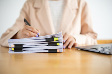 Fototapeta premium Business Documents, Auditor businesswoman checking searching document legal prepare paperwork or report for analysis TAX time,accountant Documents data contract partner deal in workplace