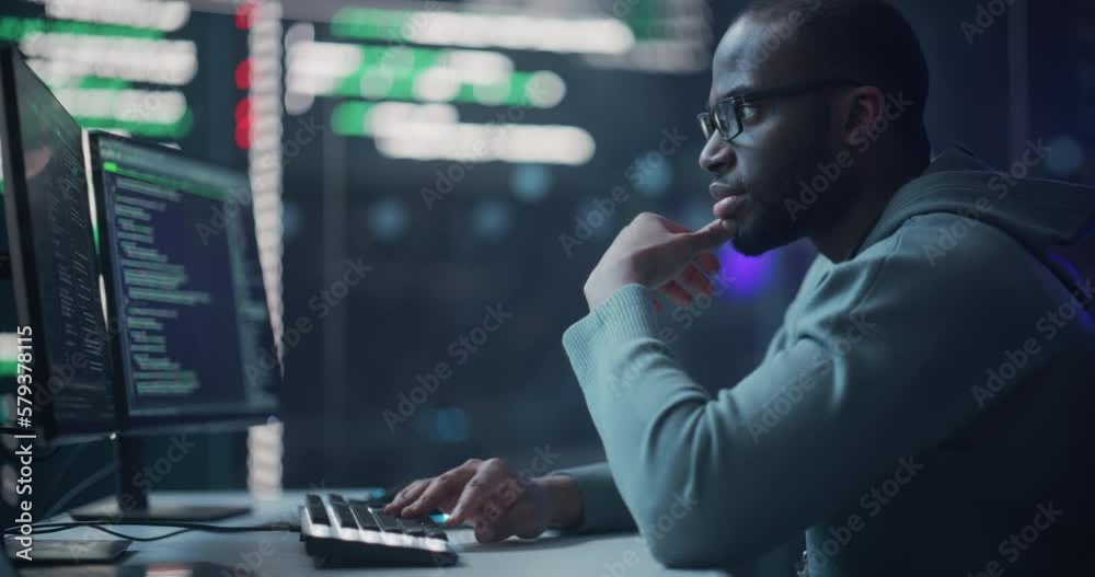 Aufkleber Black Male Programmer Working in Monitoring Room, Surrounded by Big Screens Displaying Lines of Programming Language Code. Portrait of Man Creating a Software. Abstract Futuristic Coding Concept