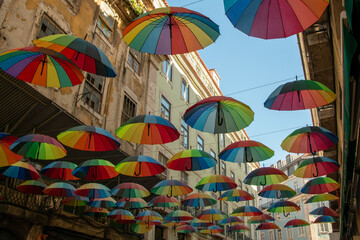 Colorful rainbow umbrellas on Pink Street in Lisbon, Portugal, Europe