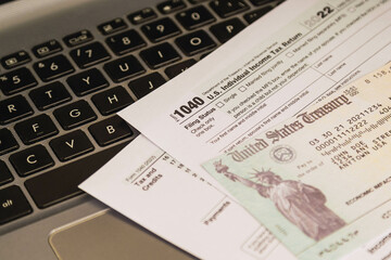 IRS 1040 tax forms , United States tax form, a laptop on a desk. US individual income tax return. Accountant working with US tax forms