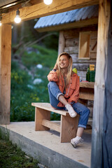 Smiling  woman  relaxing on cozy balcony in nature.