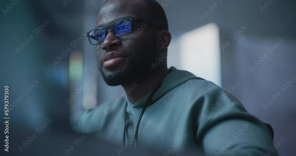Aufkleber Black Male Developer Smiling Happily After Successfully Typing on Computer a Functioning Software Code. Professional Programmer Creating a Mobile App, Screen Display Reflected on his Glasses