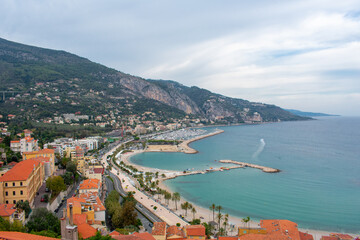 Menton, France Aerial view on buildings in old town and coast of see. Narrow romantic street between houses. 