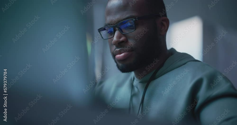 Aufkleber Close Up Portrait of Black Man Working on Computer, Lines of Code Language Reflecting on his Glasses. Male Programmer Developing New Software, Managing Cybersecurity Project. Slow Motion