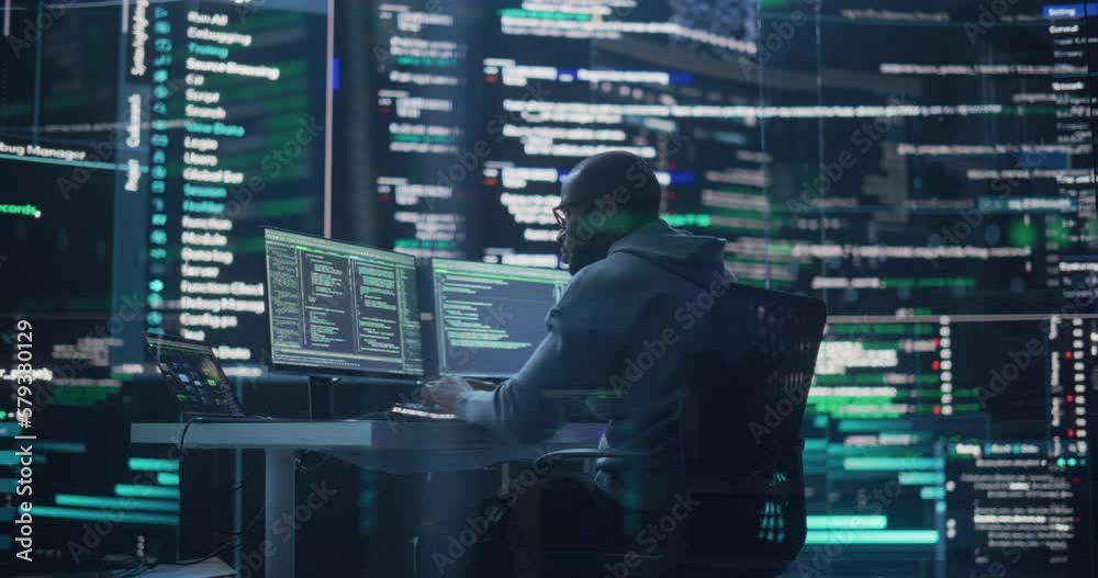 Aufkleber Medium Shot of a Man Working as a Developer, Surrounded by Big Screens Displaying Lines of Code in a Monitoring Room. Black Male Programmer Using Desktop Computer, Analysing Data, Creating AI Software