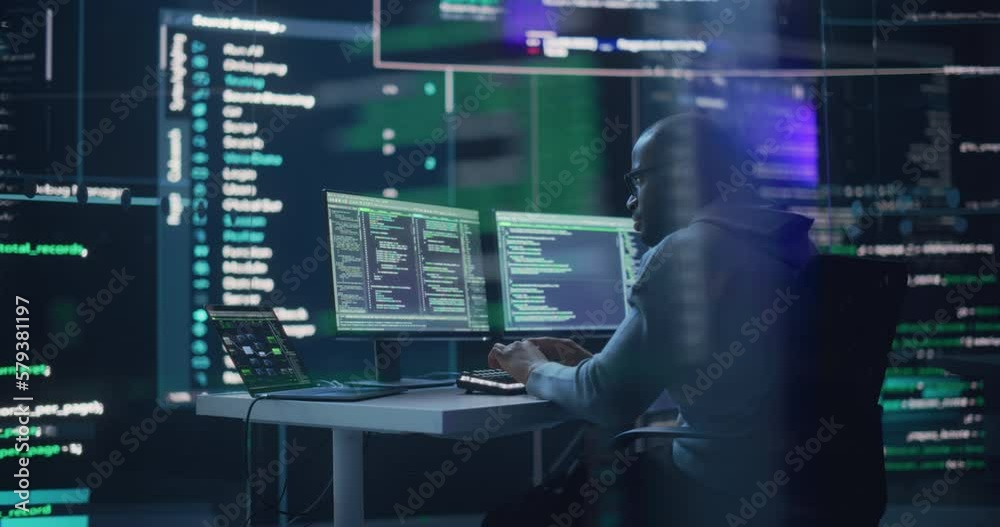 Aufkleber Portrait of a Black Man Working on Computer, Typing Lines of Code that Appear on Big Screens Surrounding him in Monitoring Room. Male Programmer Creating Innovative Software Using AI Data and System