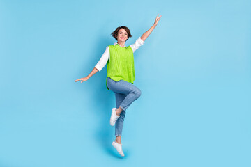 Full length photo of adorable lovely woman with bob hairstyle wear green waistcoat jumping flying isolated on blue color background