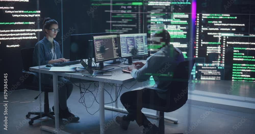 Fototapete Diverse Young Man and Woman Working on Desktop Computers, Surrounded by Big Screens Displaying Code Lines. Professional Computer Engineers Developping Autonomous Algorithm for Generative AI