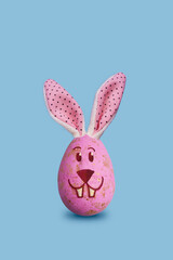 Easter bunny egg decoration on pastel blue background