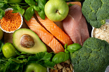 healthy vegetables, cereals, meat and greens on a gray background.