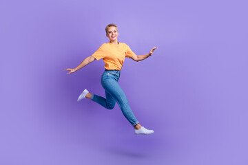 Fototapeta na wymiar Full size profile portrait of cheerful pretty girl jump run hurry empty space isolated on purple color background