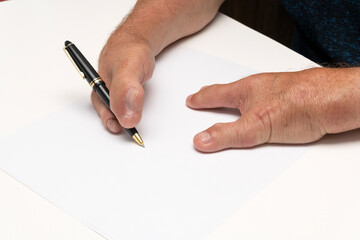 Special hands holding a pen on a white piece of paper