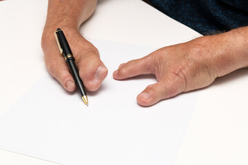 Special hands holding a pen on a white piece of paper