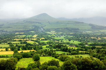 Obraz premium County Tipperary. South across lush green field farmland of the Glen of Aherlow to the Galtee Mountains. Ireland