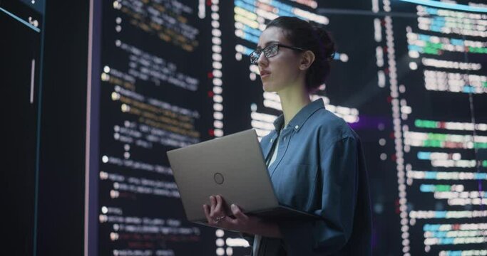Portrait of Woman Creating a Software and Coding, Surrounded by Big Screens Displaying Lines of Programming Language Code. Female Programmer Working in a Monitoring Control Room. Futuristic Concept
