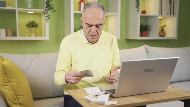 Confused old man looking at overpriced bill.
The price on the receipt or invoice surprises the old man, the old man paying online is angry.
