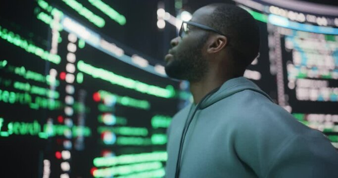 Portrait of Worried Professional Programmer Fixing a Bug, Dealing with Crashing System. Young Black Man Looking at Big Digital Screens Glitching While Displaying Code Lines, Thinking of Solutions