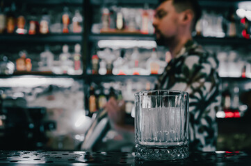 man hand bartender making cocktail in glass on the bar counter