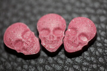 Obraz na płótnie Canvas Pink skull ecstasy pill close up background high quality prints purple army dope narcotics substance high dose psychedelic way of feeling life