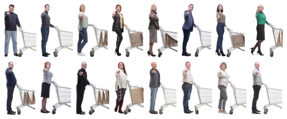 a group of people with a shopping cart point their finger at the camera