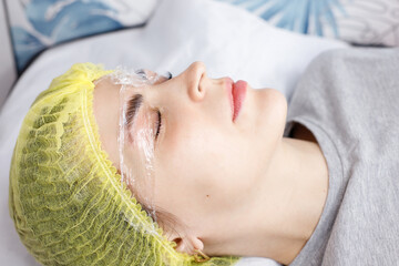 Woman doing eyebrow lamination with composition close-up