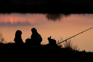 Two little boy brothers fishing in late night on their own.