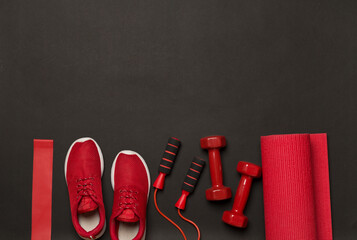 Red sport equipment on color background, top view