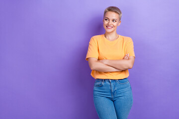 Photo of confident attractive positive business manager wear orange t-shirt folded arms look empty space novelty isolated on violet color background
