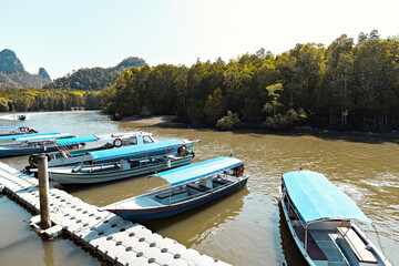Boats on the water in Kilim Geoforest Park Malaysia