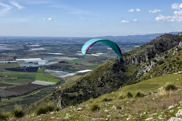 Paragliding concept, paraglider pilot fly in sky on beauty nature mountain landscape Norma Italy...
