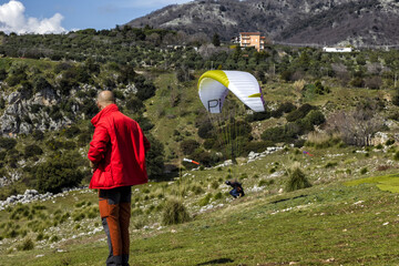 Paragliding concept, paraglider pilot fly in sky on beauty nature mountain landscape Norma Italy...