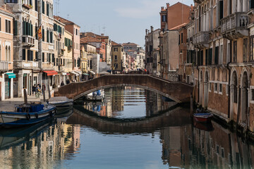 Fototapeta na wymiar A beautiful and charming view of a canal in Venice, Italy, during early spring showing its typical architecture 
