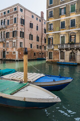 A beautiful and charming view of a canal in Venice, Italy, during early spring showing its typical architecture 