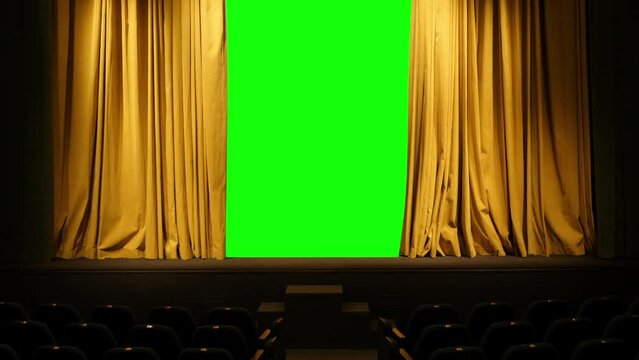 The theatrical curtain of mustard color in the hall on the stage Rachdvdi is in both strorons a green background behind it. Overall plan.