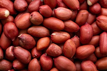 Top view closeup shot of a heap of raw peanuts